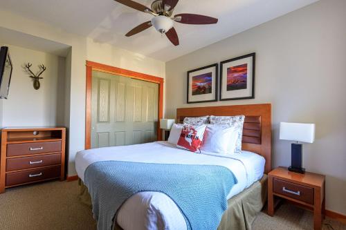 a bedroom with a bed and a ceiling fan at Alpine at The Lodges of Canmore in Canmore