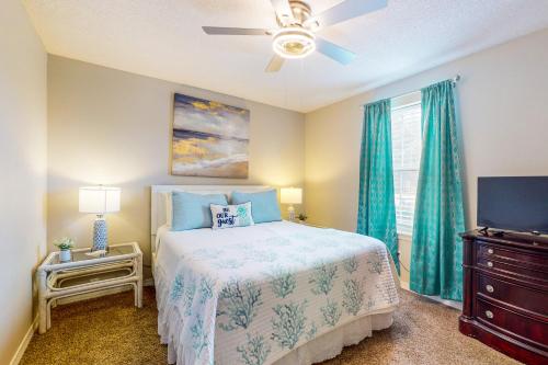 a bedroom with a bed and a ceiling fan at Pretty in Perdido Key in Perdido Key