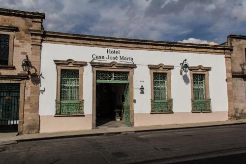 un edificio blanco con puertas verdes en una calle en Casa Jose Maria, en Morelia