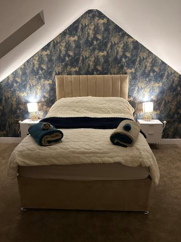 a bedroom with a bed with two towels on it at The Cleveland Retreat - sauna stay in Boosbeck