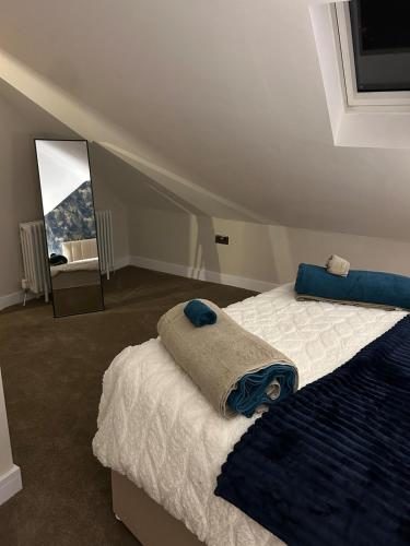 a bedroom with a large bed and a mirror at The Cleveland Retreat - sauna stay in Boosbeck