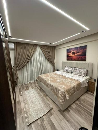 a bedroom with a bed and a painting on the ceiling at Luxury apartment with garden in Janna 2 sheikh Zayed in Sheikh Zayed