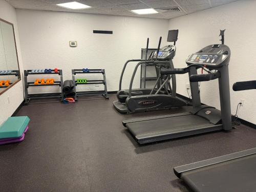 a gym with a treadmill and other equipment in a room at Sonesta Essential - Rapid City in Rapid City