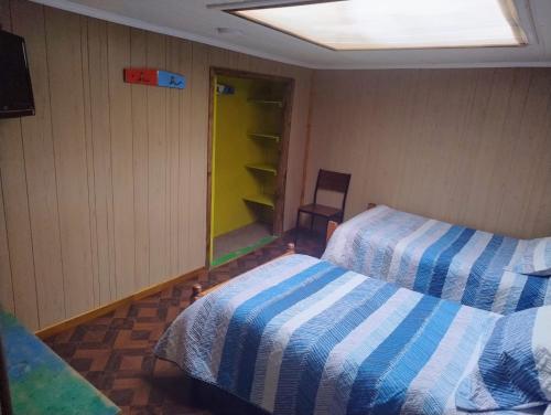 Кровать или кровати в номере Hostal y Residencial El Mundial