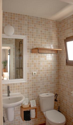 a bathroom with a toilet and a sink and a mirror at Hostal La Torre Ibiza Cap Negret in San Antonio