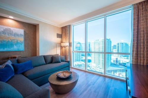 a living room with a couch and a large window at No Resort Fee Strip View Suite +Free Valet + Pool in Las Vegas