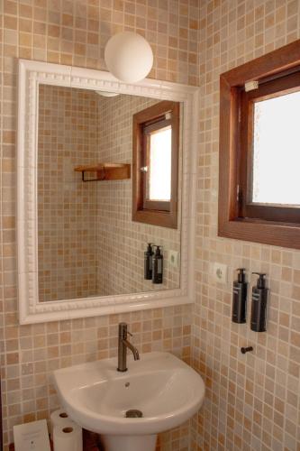 a bathroom with a sink and a mirror at Hostal La Torre Ibiza Cap Negret in San Antonio