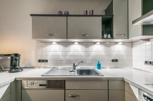 a kitchen with a sink and a counter top at Modern apartment, that's how you live in Lorsch