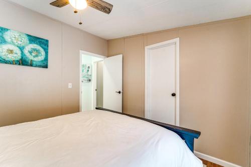 a bedroom with a bed and a painting on the wall at Half-Mi to Lakemont Park Family-Friendly Home! in Altoona