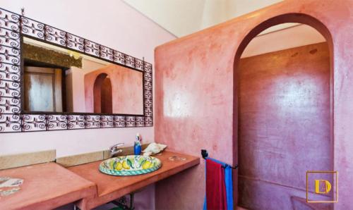 a bathroom with a sink and a mirror at Dammusi Ambra in Pantelleria