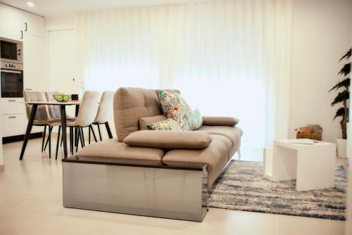 a living room with a couch and a table at Balili Home by the Sea in Ferrel