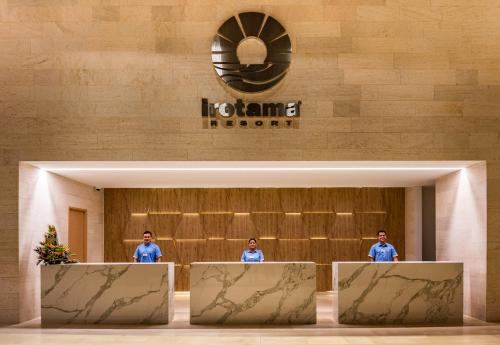 two men standing at the front of a hotel lobby at Hotel Irotama Lago in Santa Marta