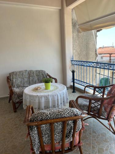 a living room with a table and chairs on a balcony at Seaside Apartment in Vergia in Vergia