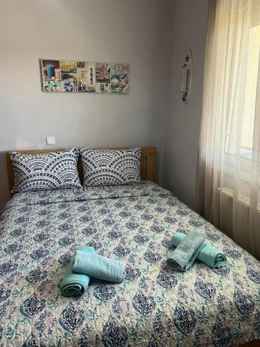 a bed with two pairs of towels on it at Seaside Apartment in Vergia in Vergia