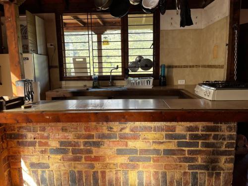a kitchen with a brick counter with a sink at Cabaña Tipo Chalet in Machetá