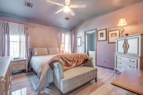 a bedroom with a bed and a chair and a window at Boho-Chic Retreat with Yard, 22 Mi to Dtwn Austin! in Kyle