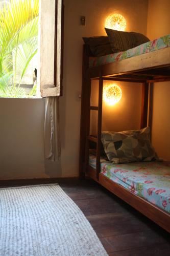 a bedroom with two bunk beds and a window at Centro Cultural do Bispo Guesthouse in Salvador