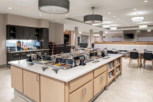 a kitchen with a large island in the middle at Homewood Suites by Hilton Anaheim Conv Ctr/Disneyland Main in Anaheim