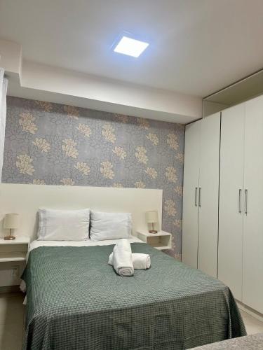 a bedroom with a bed with two towels on it at Equilíbrio 1316 in Sao Jose do Rio Preto