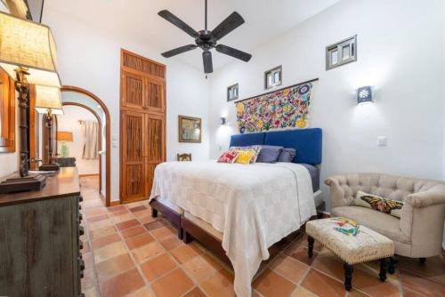 a bedroom with a bed and a ceiling fan at Casa Amor Ocean Front Isla Mujeres in Isla Mujeres