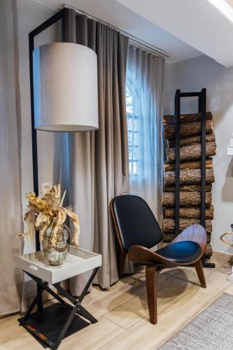 a living room with a chair and a table at Agata Hotel Boutique & Spa in Mexico City