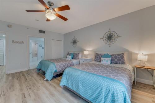 a bedroom with two beds and a ceiling fan at Unit 2328 Ocean Walk - 2 Bedroom Ocean View in Daytona Beach