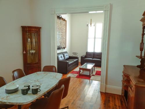 a living room with a table and a couch at Barrabool Maze Estate in Ceres