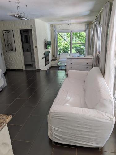 a bedroom with a large white bed in a room at Casa Pura Vida in Punta del Este