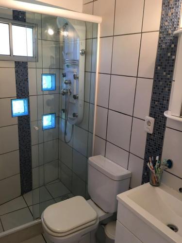 a bathroom with a shower and a toilet and a sink at Casa Pura Vida in Punta del Este