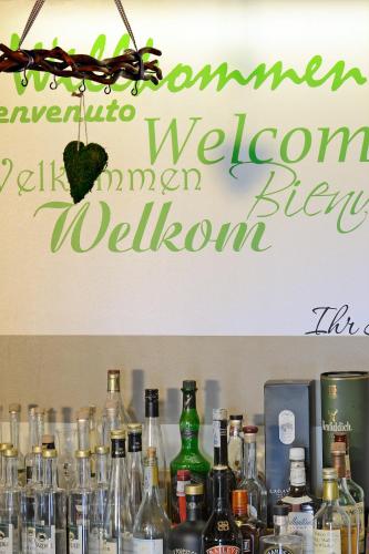 a sign on a wall with bottles of alcohol at Hotel Storchen in Rheinfelden