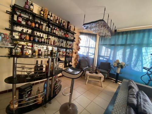 a room with a bar with shelves of alcohol at Amplia casa con piscina y vista al mar in Cartagena