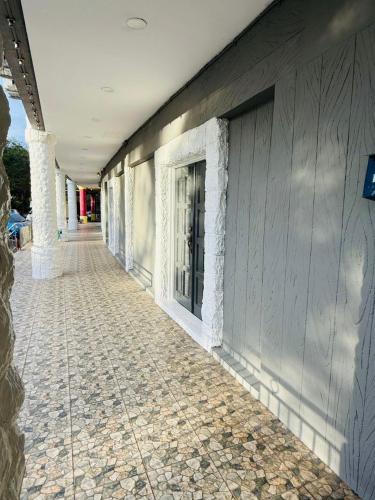 a hallway of a building with a cobblestone sidewalk at K Garden Hotel Sungai Petani in Sungai Petani