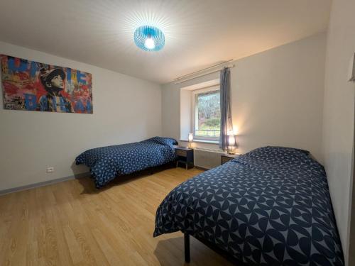 une chambre avec deux lits et une fenêtre dans l'établissement Spacieux appartement 3 chambres, proche ski et nature, WiFi, parking, animaux admis - FR-1-589-782, à Cornimont