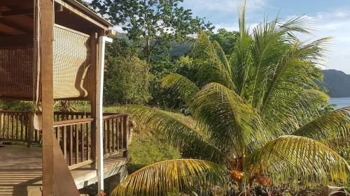 a porch of a house with a view of the water at Castara Roundhouse - Ocean View in Castara
