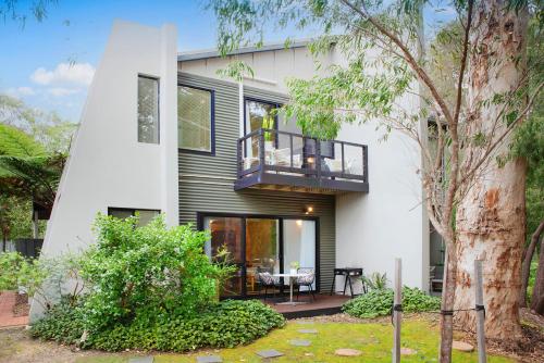 a house with a balcony and a tree at MARGARET FOREST RETREAT Apartment 129 - Located within Margaret Forest, in the heart of the town centre of Margaret River, spa apartment! in Margaret River Town
