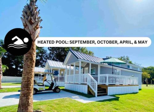 a house with a golf cart parked in front of it at Vacation Cottage North Myrtle Beach #68 in Myrtle Beach