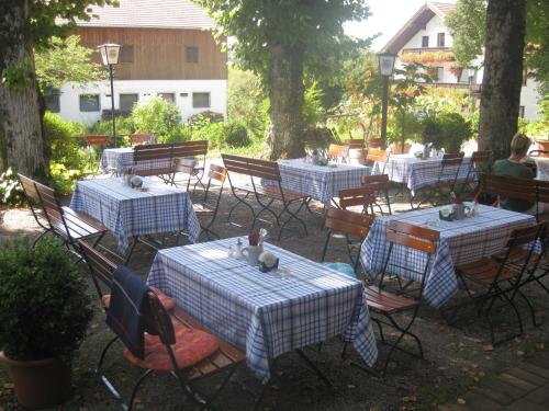 a group of tables with blue and white checkered tables at Hotel Haflhof in Egmating