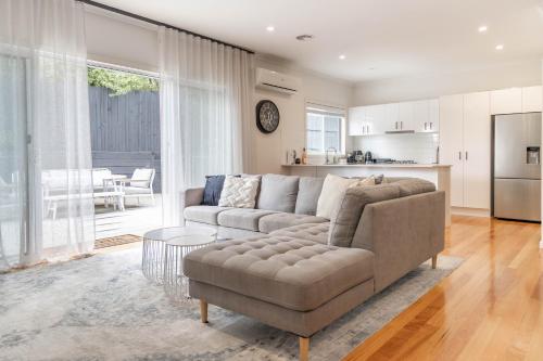 a living room with a couch and a table at Bella Boutique in Healesville