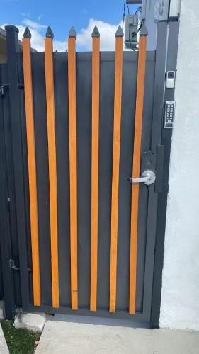 a black and orange gate with a door at Luna y Sol Calle 8 in Miami
