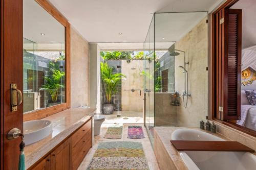 a bathroom with two sinks and a shower at Sahaja Sawah Resort in Tabanan