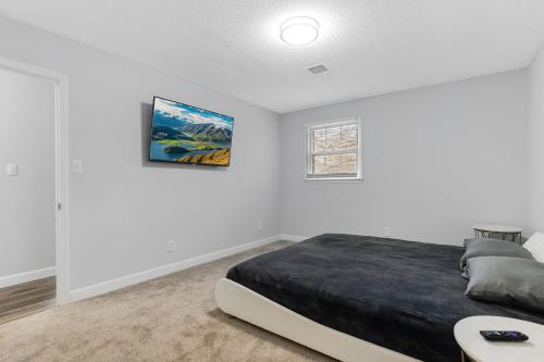 a white bedroom with a bed and a window at Spacious and private home at Boiling Springs in Boiling Springs