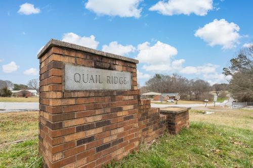 a brick wall with a sign that reads quail ridge at Spacious and private home at Boiling Springs in Boiling Springs