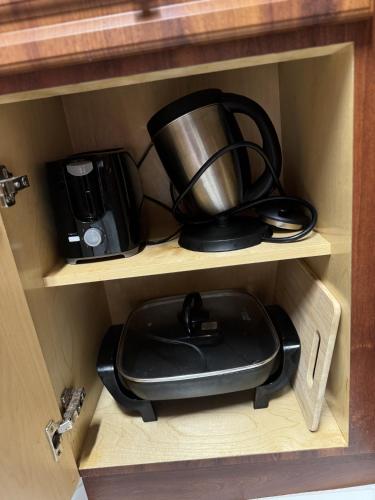 a cupboard with a coffee maker and a coffee pot at Luna y Sol Calle 8 in Miami