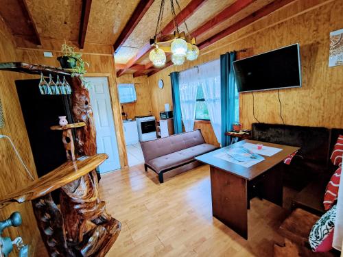 a living room with a couch and a table at Cabañas Lago Llanquihue in Llanquihue