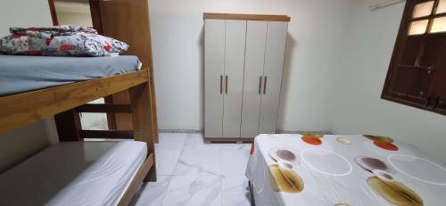 a bedroom with two bunk beds and a closet at Paraíso no Velho Chico in Canindé de São Francisco