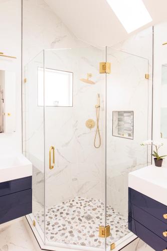 a bathroom with a shower with a glass door at Lux Newly Remodeled DT, Patio, Fully Stocked 5Bd, 3Ba in Denver