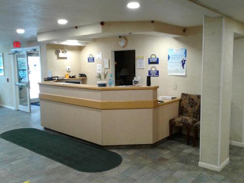 a lobby of a hospital with a reception counter at Sturbridge Plaza Hotel in Sturbridge