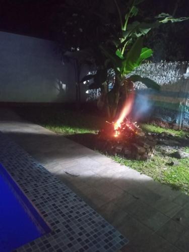 a fire pit in the yard at night at CASABLANCA, la calidez de tu hogar en Villeta in Villeta