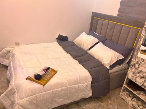 a bedroom with a bed with a tray on it at Pryme Apartment in Lagos