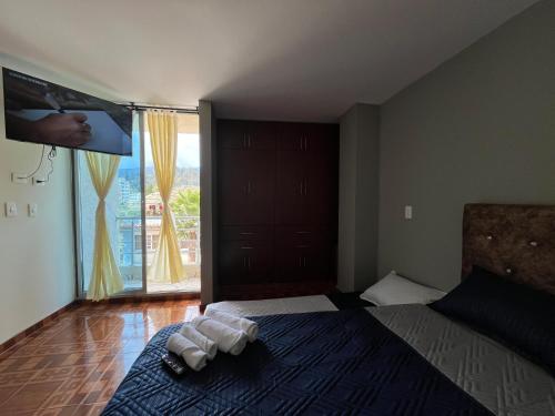 a bedroom with a bed with towels on it at Apartamento Amplio con balcones Duitama in Duitama